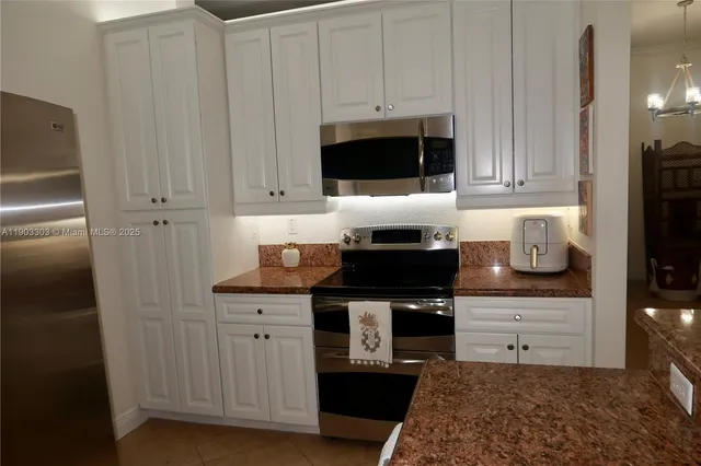 a kitchen with stainless steel appliances a stove a microwave and cabinets