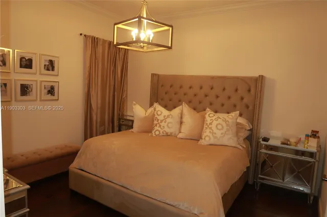 a bedroom with a bed and a chandelier