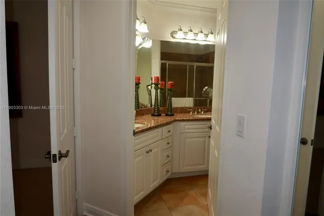 a bathroom with a mirror sink and vanity