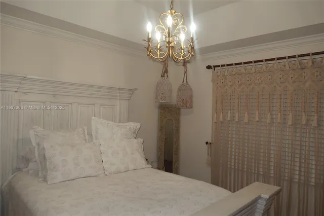 a spacious bathroom with a shower curtain and a chandelier
