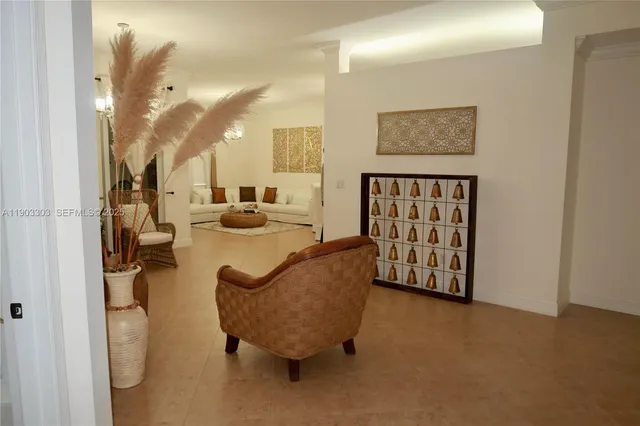 a living room with furniture and a chandelier