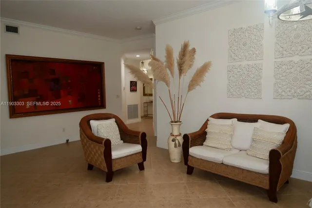 a living room with furniture and a potted plant