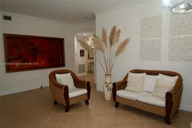 a living room with furniture and a potted plant