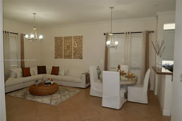 a living room with furniture and a chandelier