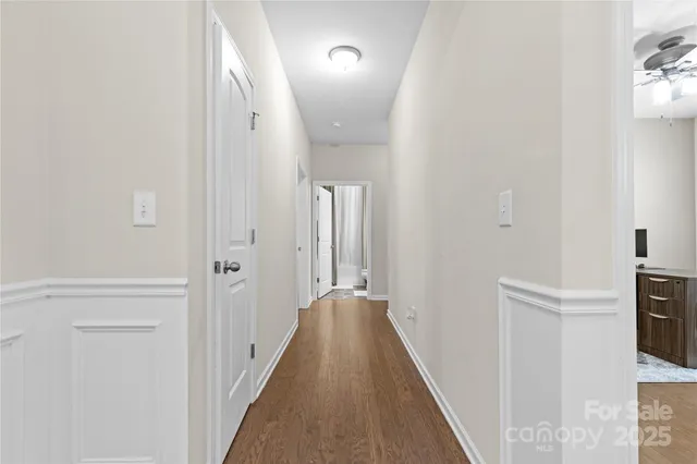 a view of a hallway with a hardwood and front door