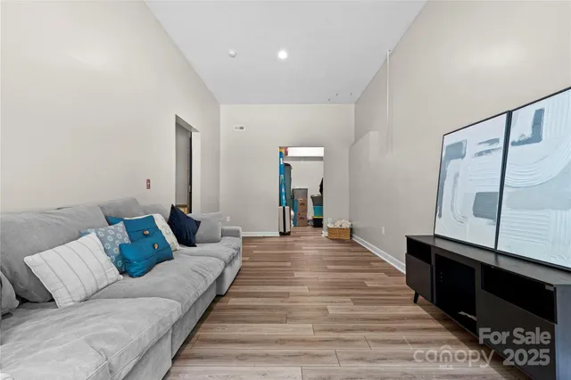 a living room with furniture and a wooden floor