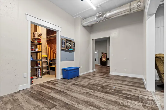 an empty room with wooden floor and closet