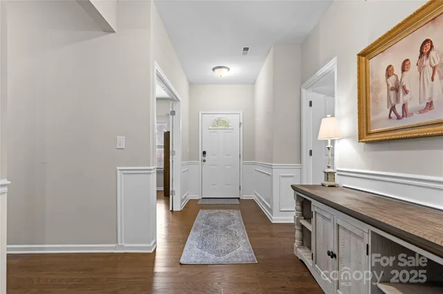 a view of a kitchen with stainless steel appliances granite countertop a refrigerator and a stove top oven