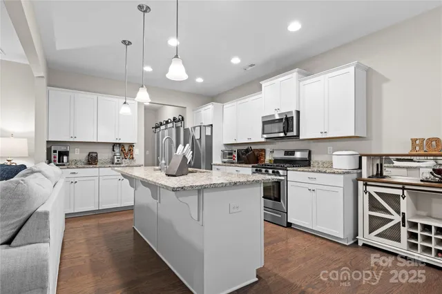 a kitchen with cabinets stainless steel appliances and a counter top space