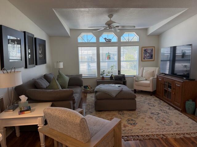 65 Turquoise Avenue Naples, FL 34114 - Photo 12 of 34 a living room with furniture a chandelier and a flat screen tv