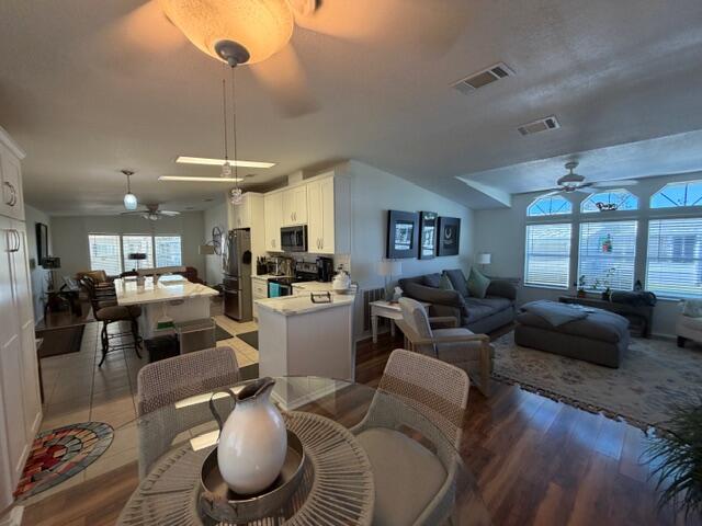 65 Turquoise Avenue Naples, FL 34114 - Photo 16 of 34 a living room with furniture kitchen and a chandelier