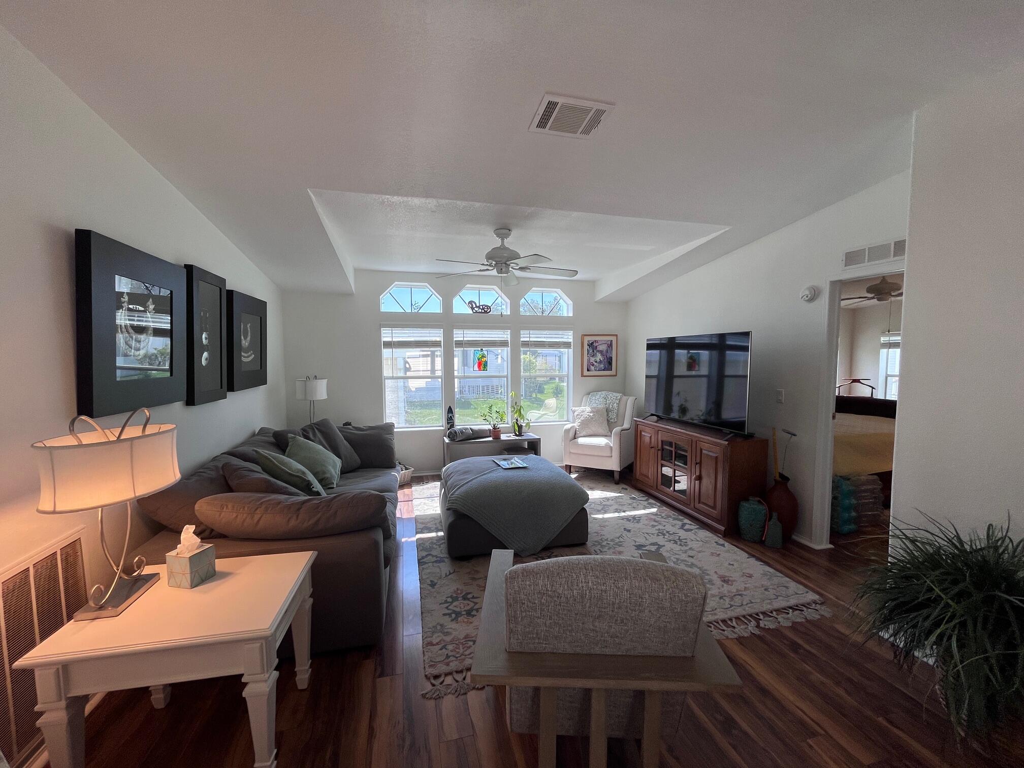 65 Turquoise Avenue Naples, FL 34114 - Photo 17 of 34 a living room with furniture a flat screen tv and a large window