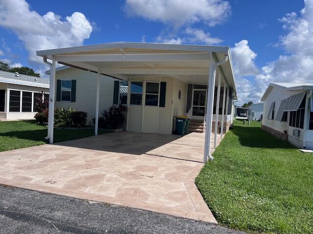65 Turquoise Avenue Naples, FL 34114 - Photo 2 of 34 a front view of a house with a yard and potted plants