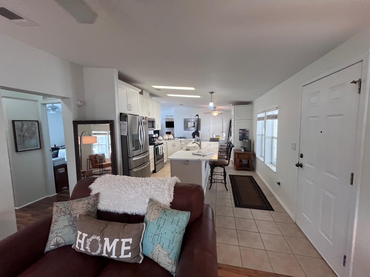 65 Turquoise Avenue Naples, FL 34114 - Photo 22 of 34 a living room with furniture and view of kitchen