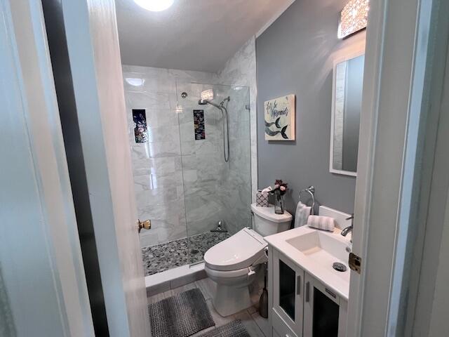 65 Turquoise Avenue Naples, FL 34114 - Photo 26 of 34 a bathroom with a sink a toilet and shower