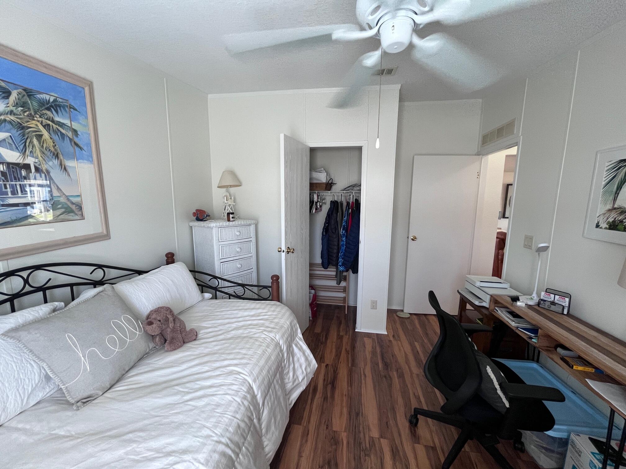 65 Turquoise Avenue Naples, FL 34114 - Photo 27 of 34 a bedroom with a bed and a chandelier