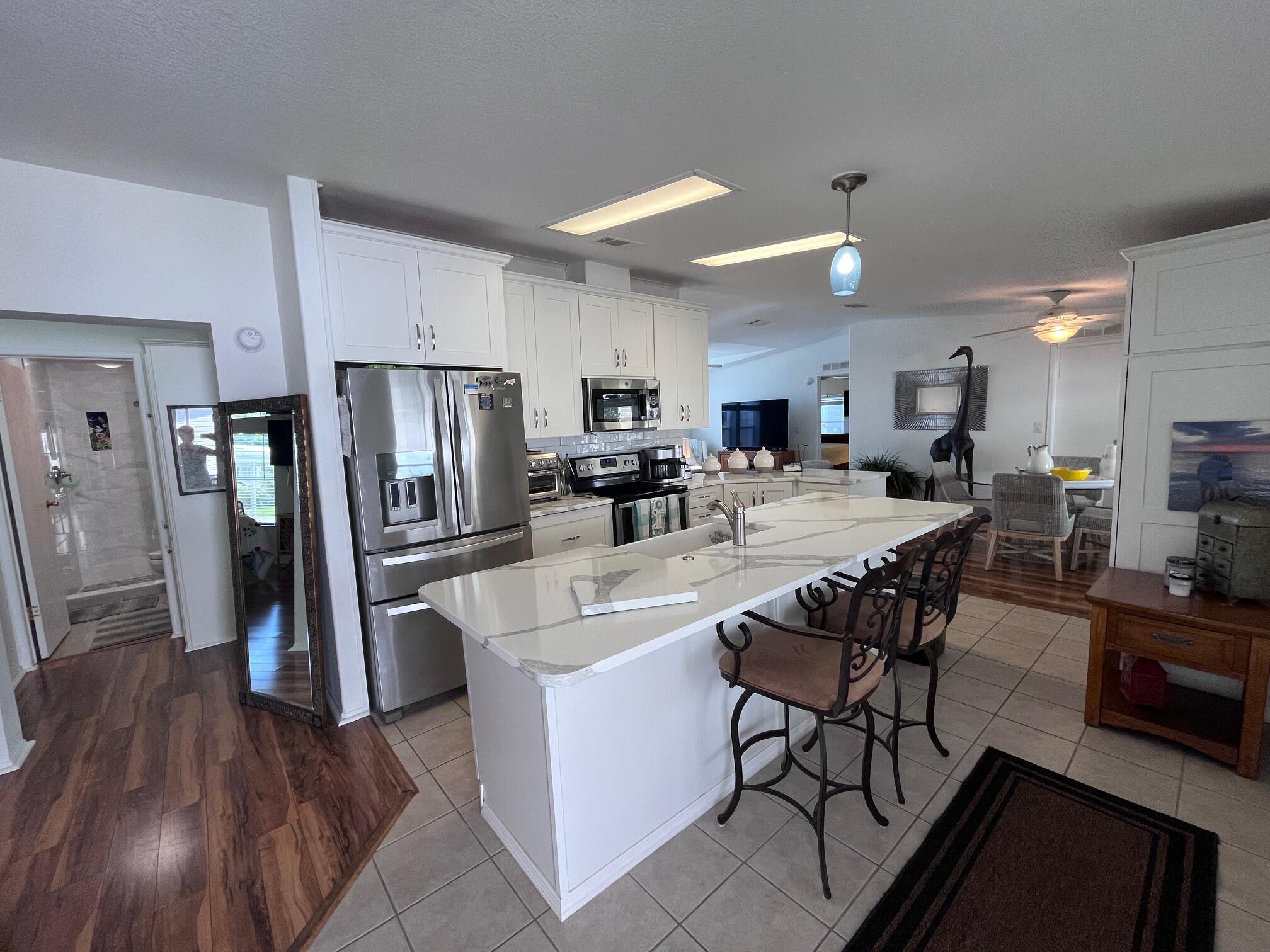 65 Turquoise Avenue Naples, FL 34114 - Photo 3 of 34 a large kitchen with a table and chairs