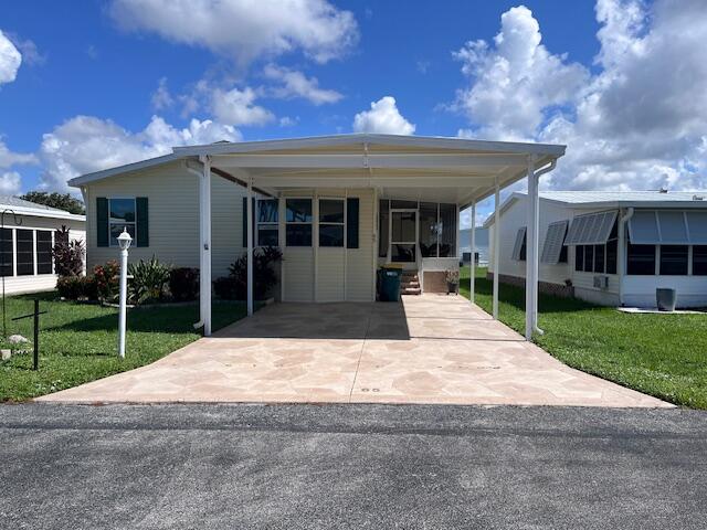 65 Turquoise Avenue Naples, FL 34114 - Photo 34 of 34 a view of a house with a yard and potted plants