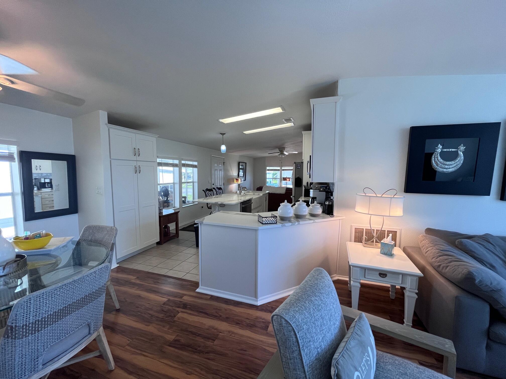 65 Turquoise Avenue Naples, FL 34114 - Photo 9 of 34 a living room with furniture and wooden floor