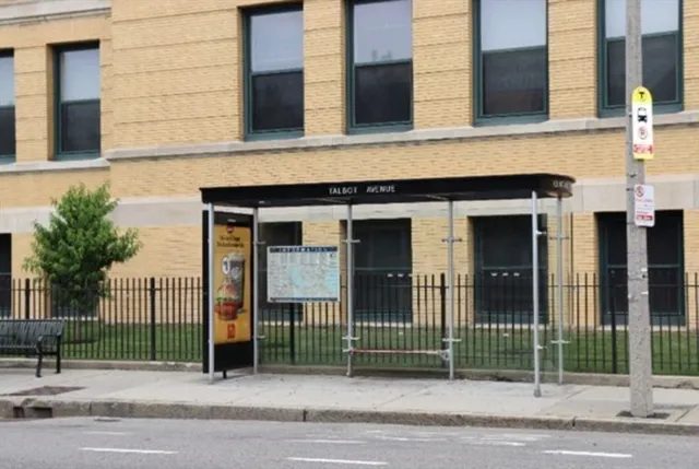 a view of a brick building next to a road
