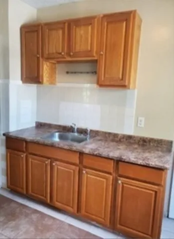 a kitchen with stainless steel appliances granite countertop wooden cabinets a sink and dishwasher