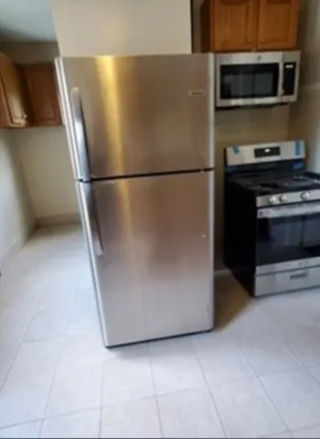 a kitchen with a refrigerator and a microwave