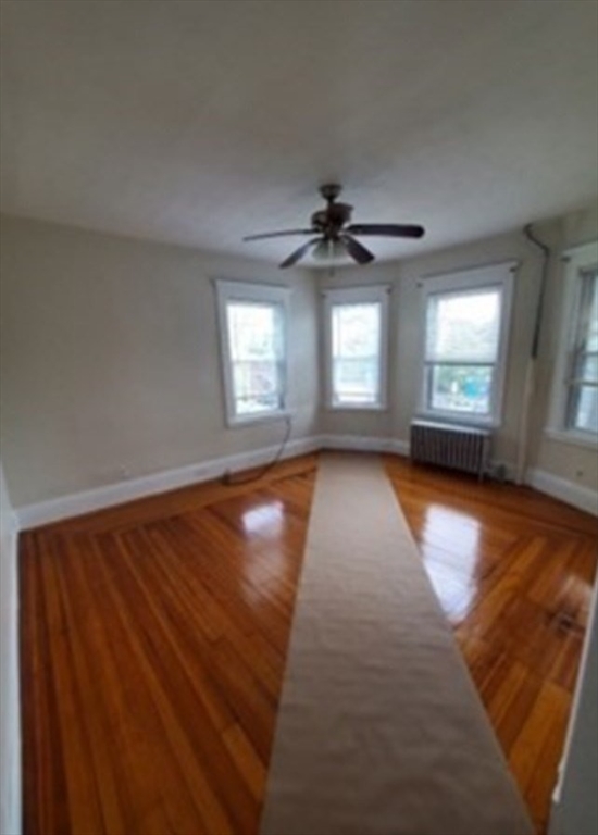 310 Talbot Avenue, Unit 2 Boston, MA 02124 - Photo 6 of 16 wooden floor in an empty room with a window
