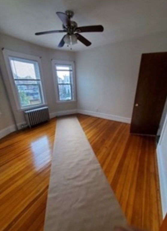 310 Talbot Avenue, Unit 2 Boston, MA 02124 - Photo 7 of 16 wooden floor in an empty room with a window
