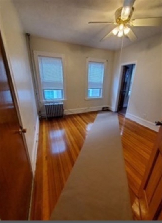 310 Talbot Avenue, Unit 2 Boston, MA 02124 - Photo 9 of 16 a view of an empty room with window and wooden floor