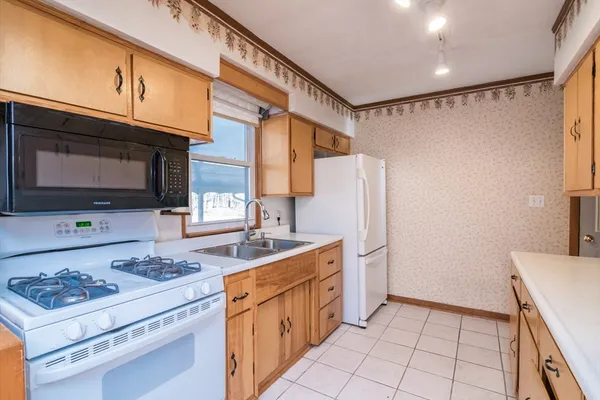 a kitchen with stainless steel appliances a stove microwave and refrigerator