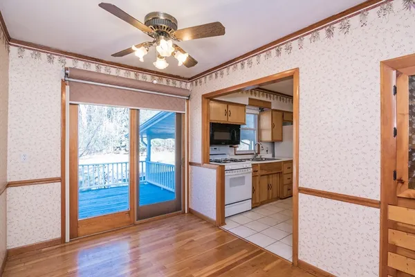 a view of an empty room window and wooden floor