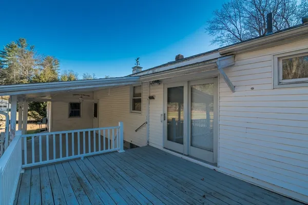 a view of a deck with wooden floor and fence