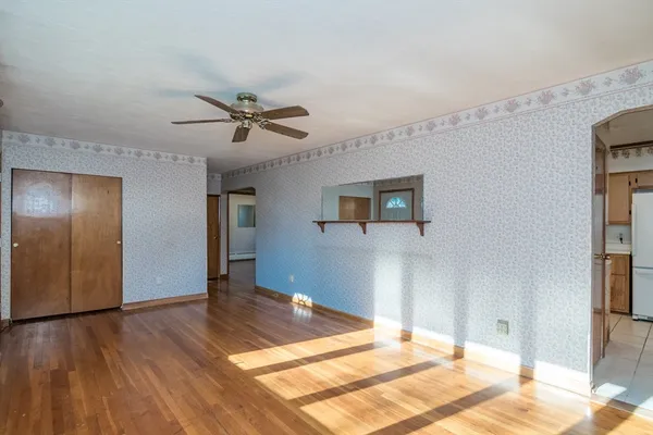a bedroom with a bed and a ceiling fan
