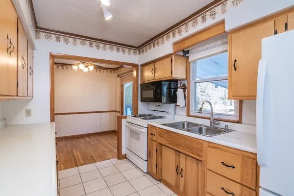a kitchen with a sink cabinets and refrigerator