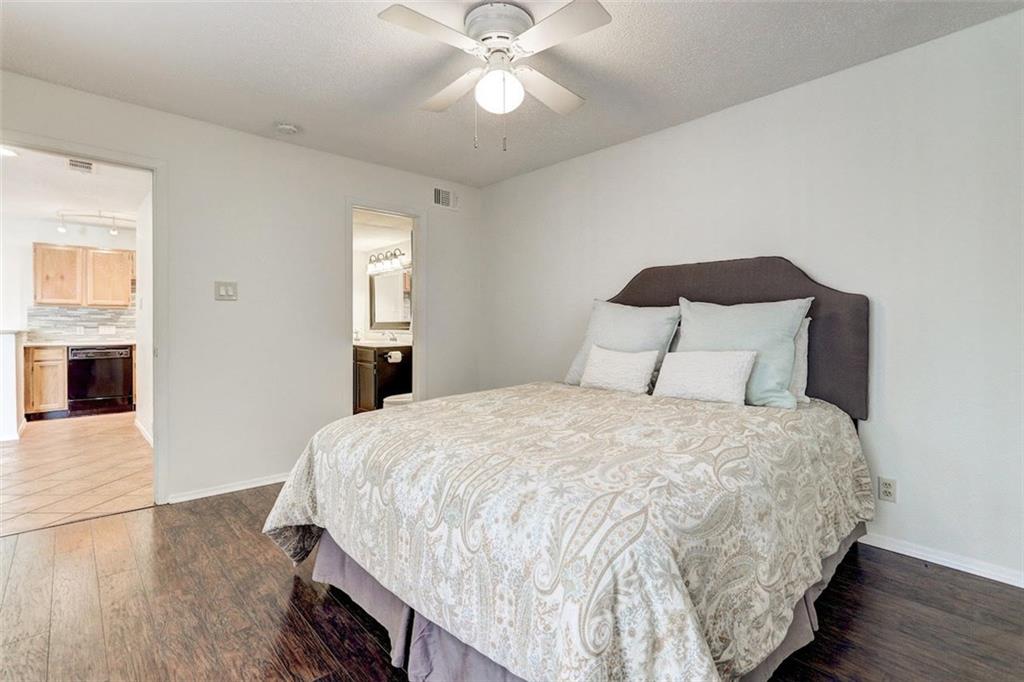 3115 Helms Street, Unit 204 Austin, TX 78705 - Photo 6 of 13 Wood flooring and a ceiling fan create a comfortable, inviting bedroom retreat.