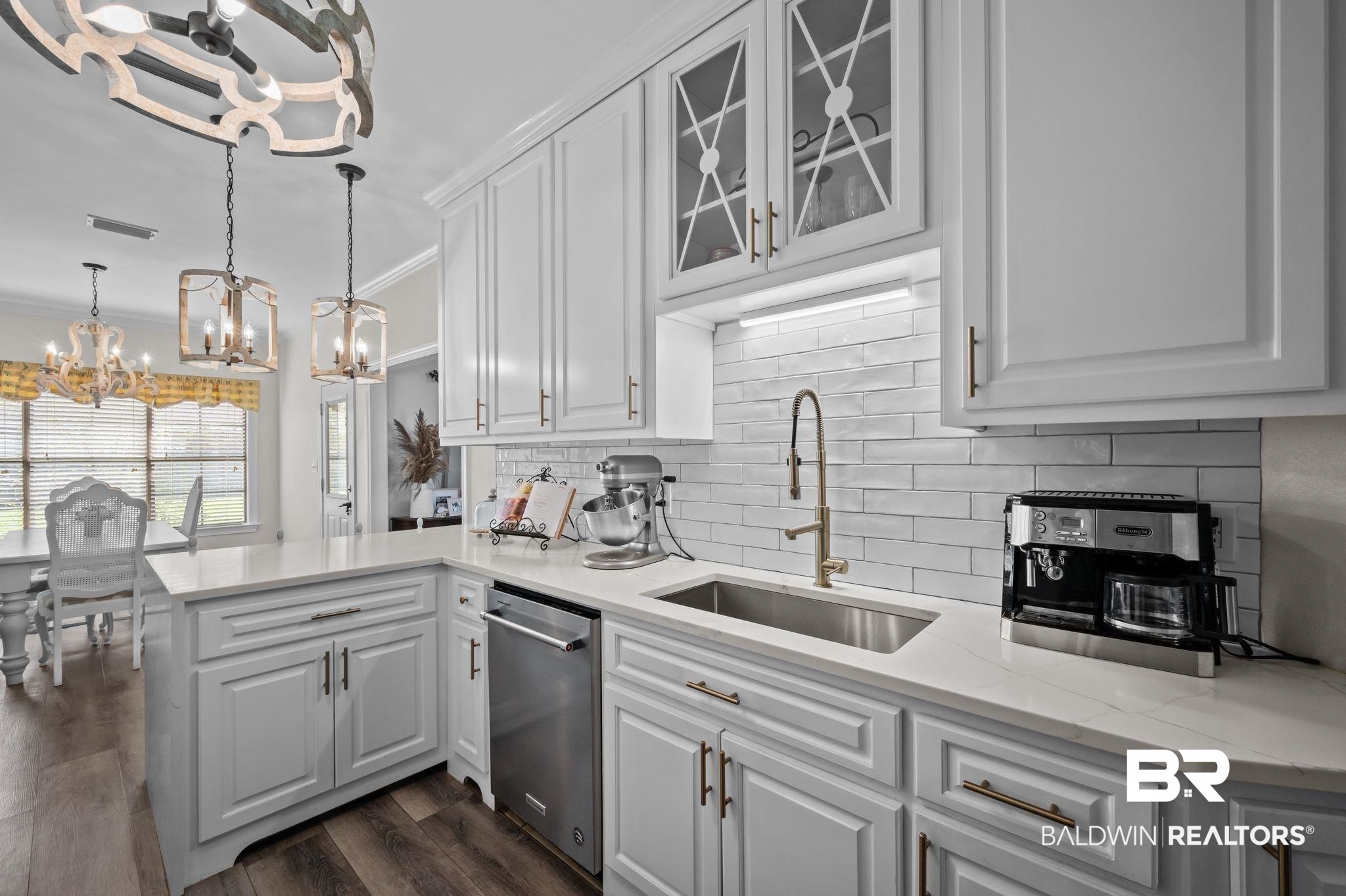 9837 Harmony Ridge Drive Semmes, AL 36575 - Photo 14 of 29 Kitchen featuring a notable chandelier, a sink, dishwasher, visible vents, and white cabinets