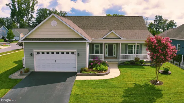a view of a house with a yard fire pit table and chairs