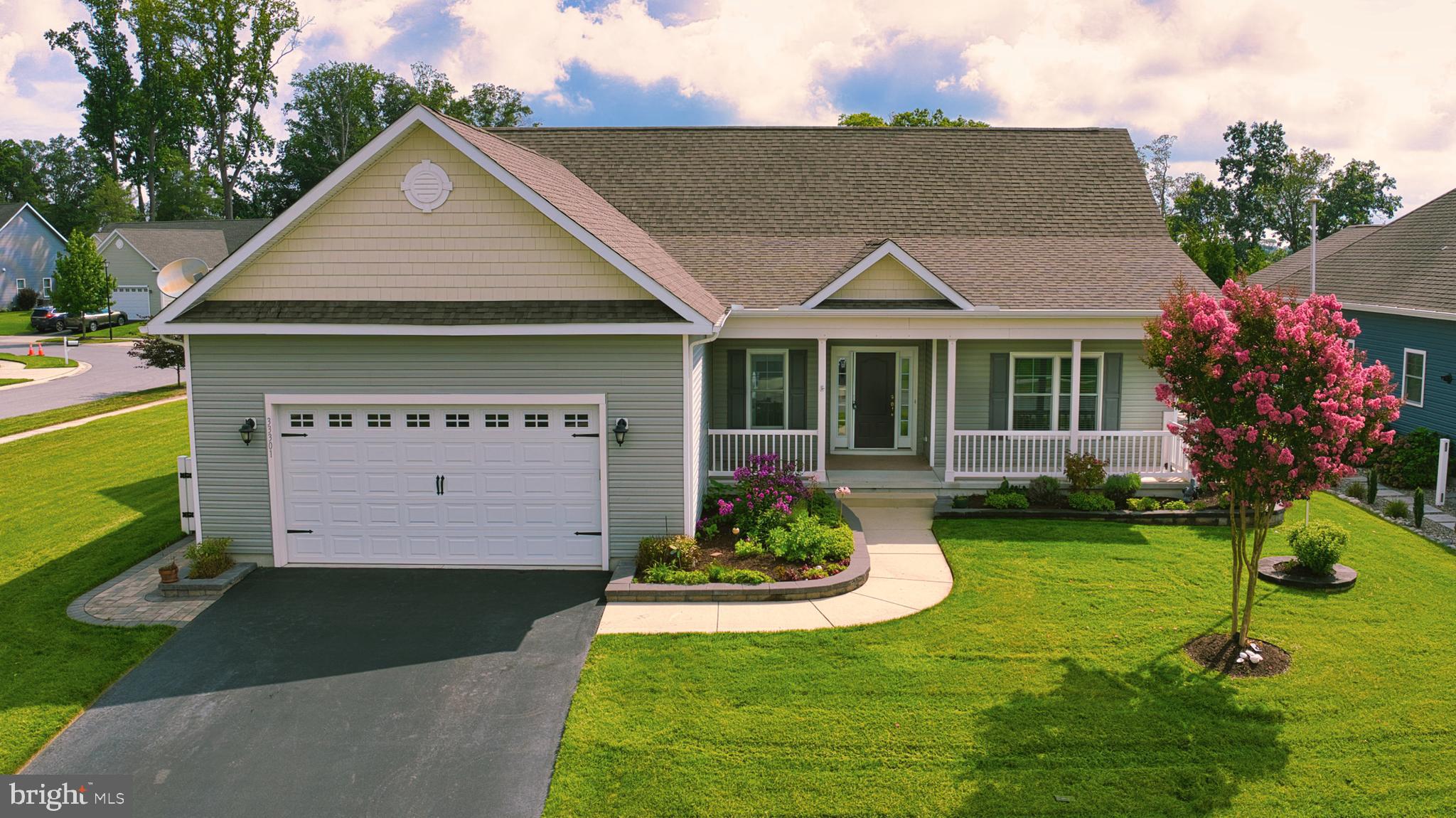 a view of a house with a yard fire pit table and chairs