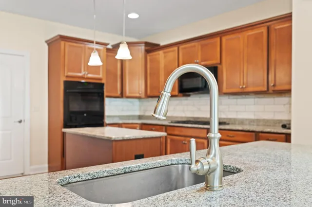 a view of a kitchen area with a sink and cabinets