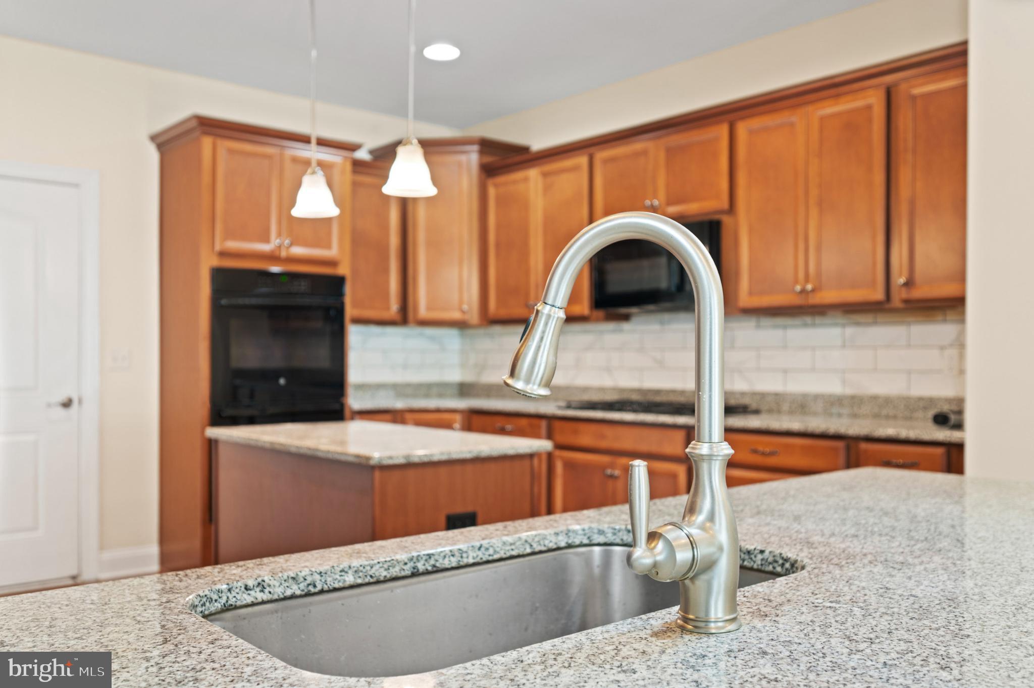33301 Bayberry Court Dagsboro, DE 19939 - Photo 13 of 44 a view of a kitchen area with a sink and cabinets