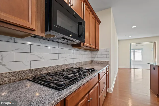 a kitchen with a stove a sink and a microwave