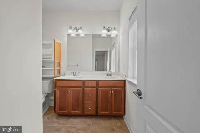 a bathroom with a granite countertop sink a mirror and a bathtub