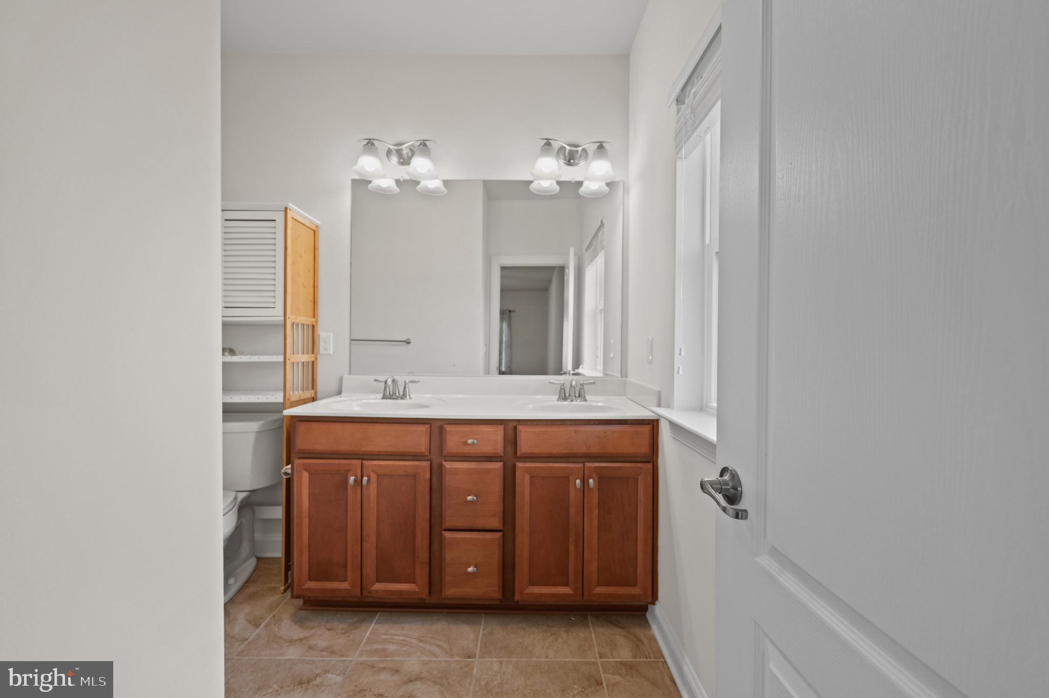 33301 Bayberry Court Dagsboro, DE 19939 - Photo 22 of 44 a bathroom with a granite countertop sink a mirror and a bathtub