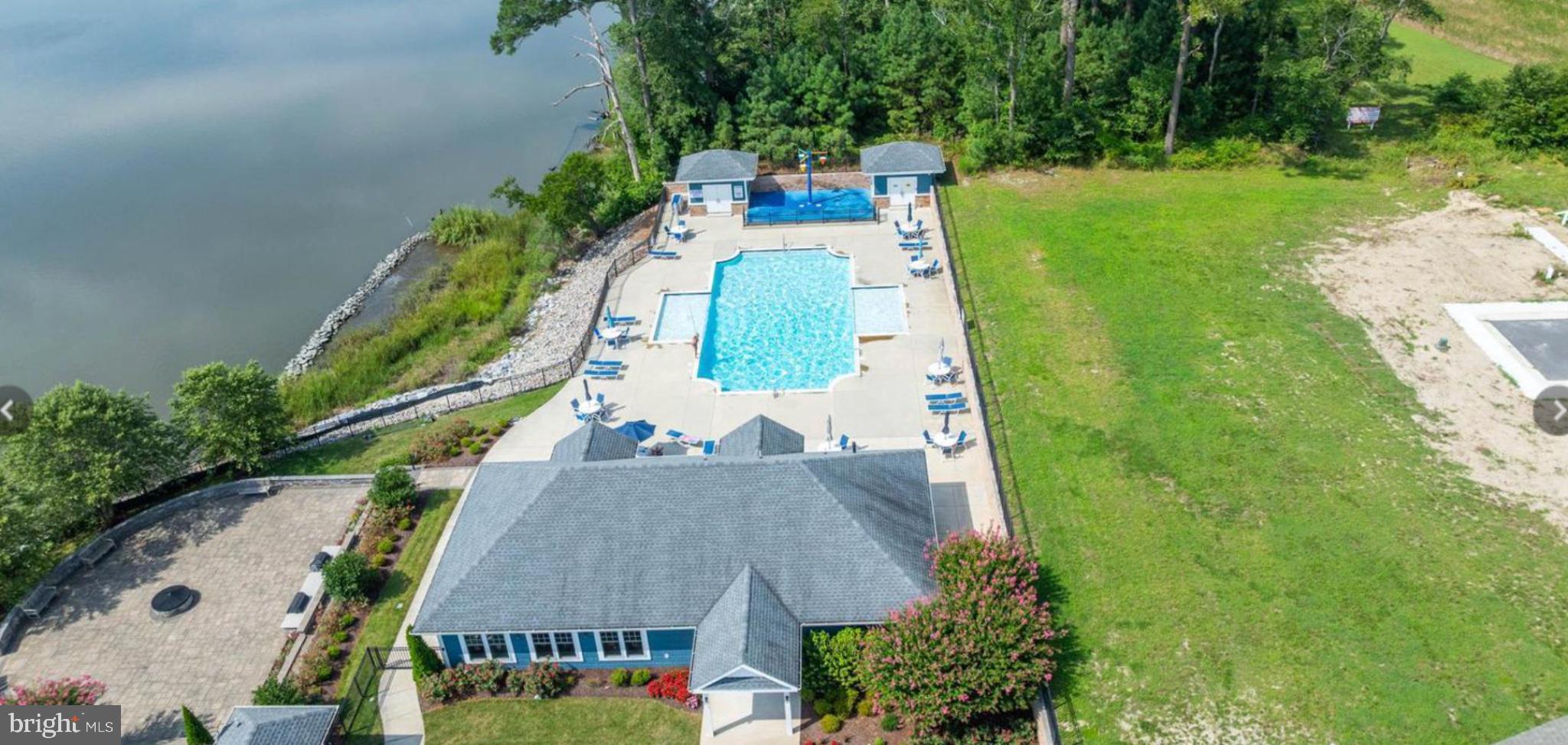 33301 Bayberry Court Dagsboro, DE 19939 - Photo 43 of 44 an aerial view of a house with a garden and trees