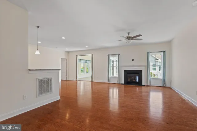 a view of an empty room with a fireplace and a window