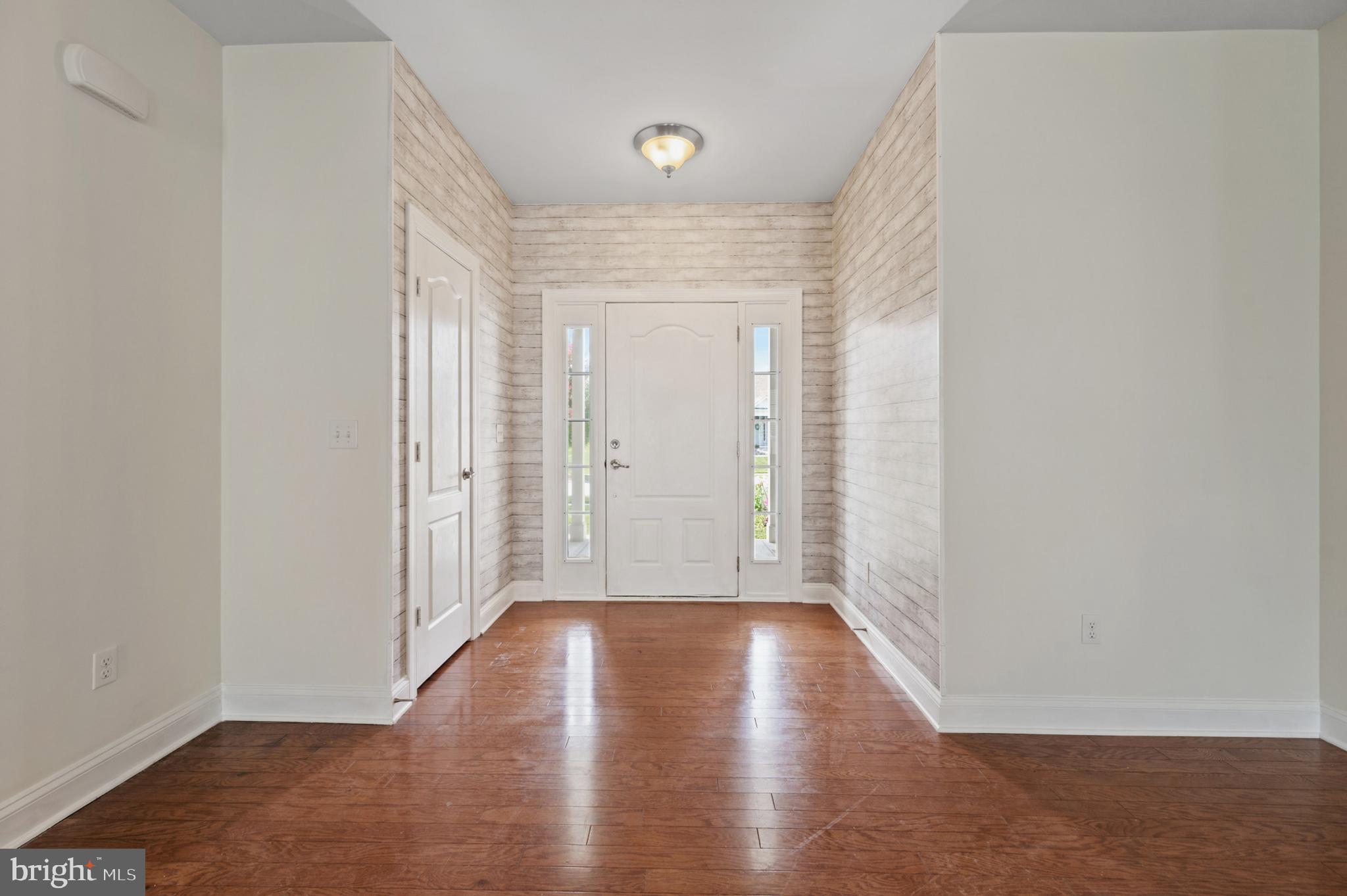 33301 Bayberry Court Dagsboro, DE 19939 - Photo 10 of 44 an empty room with wooden floor and windows
