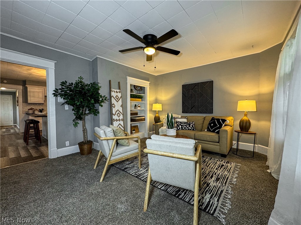 306 Robinson Road Campbell, OH 44405 - Photo 5 of 21 Carpeted living room featuring ceiling fan