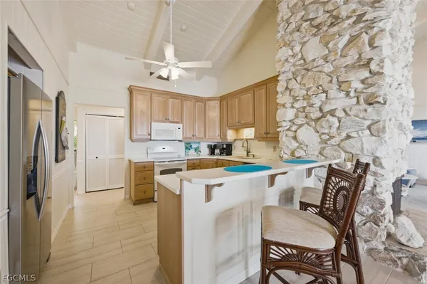 a kitchen with stainless steel appliances white cabinets and a refrigerator