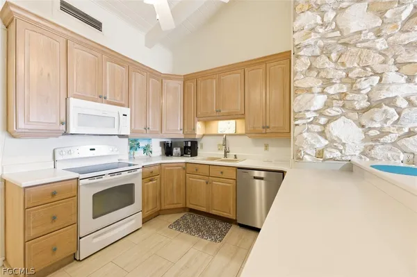 a kitchen with a sink stove and cabinets