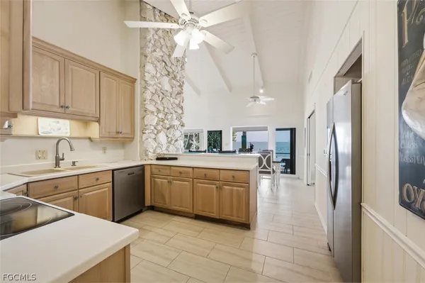 a kitchen with stainless steel appliances granite countertop a sink and a refrigerator
